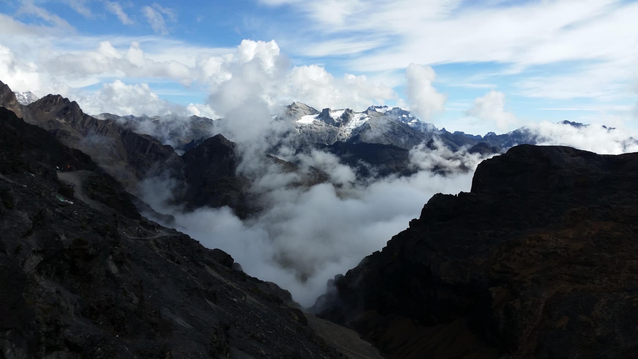 High Andean ridges above the La Cumbre pass, cloud spilling over the crest.