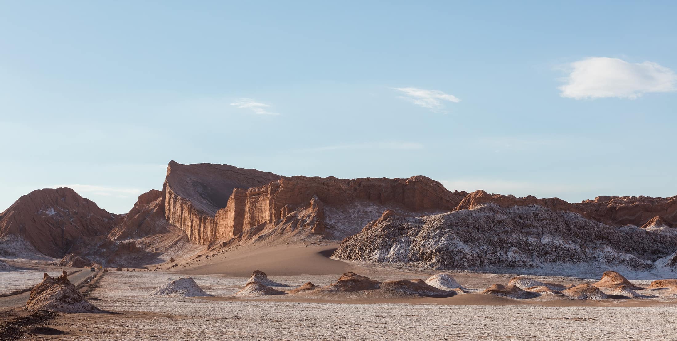 Eroded rock walls of the Valle de la Luna standing over the salt floor.