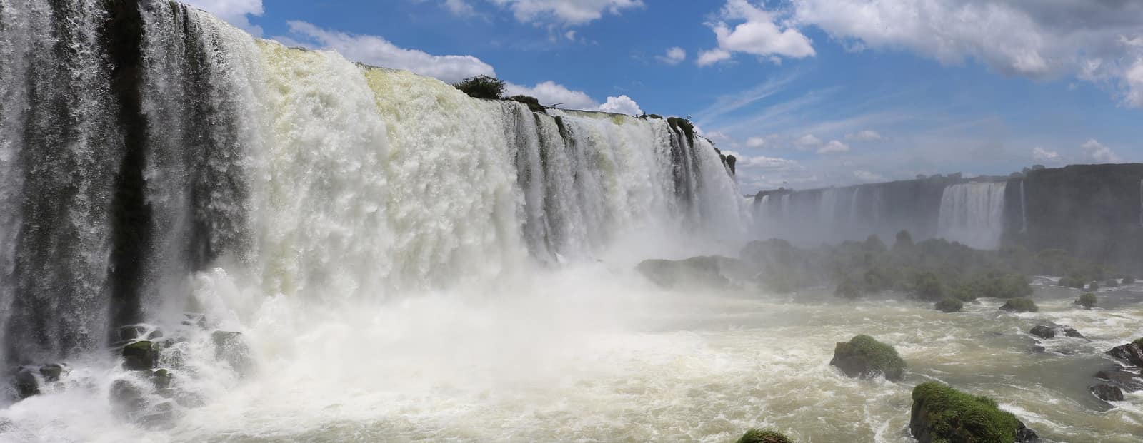 The Iguazú cataracts stepping through subtropical forest.
