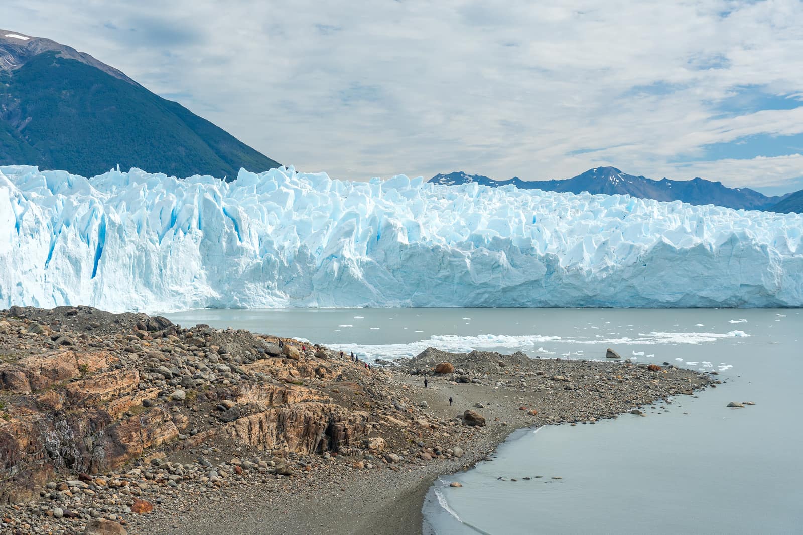 A roped line of walkers crossing the broken ice of Perito Moreno.